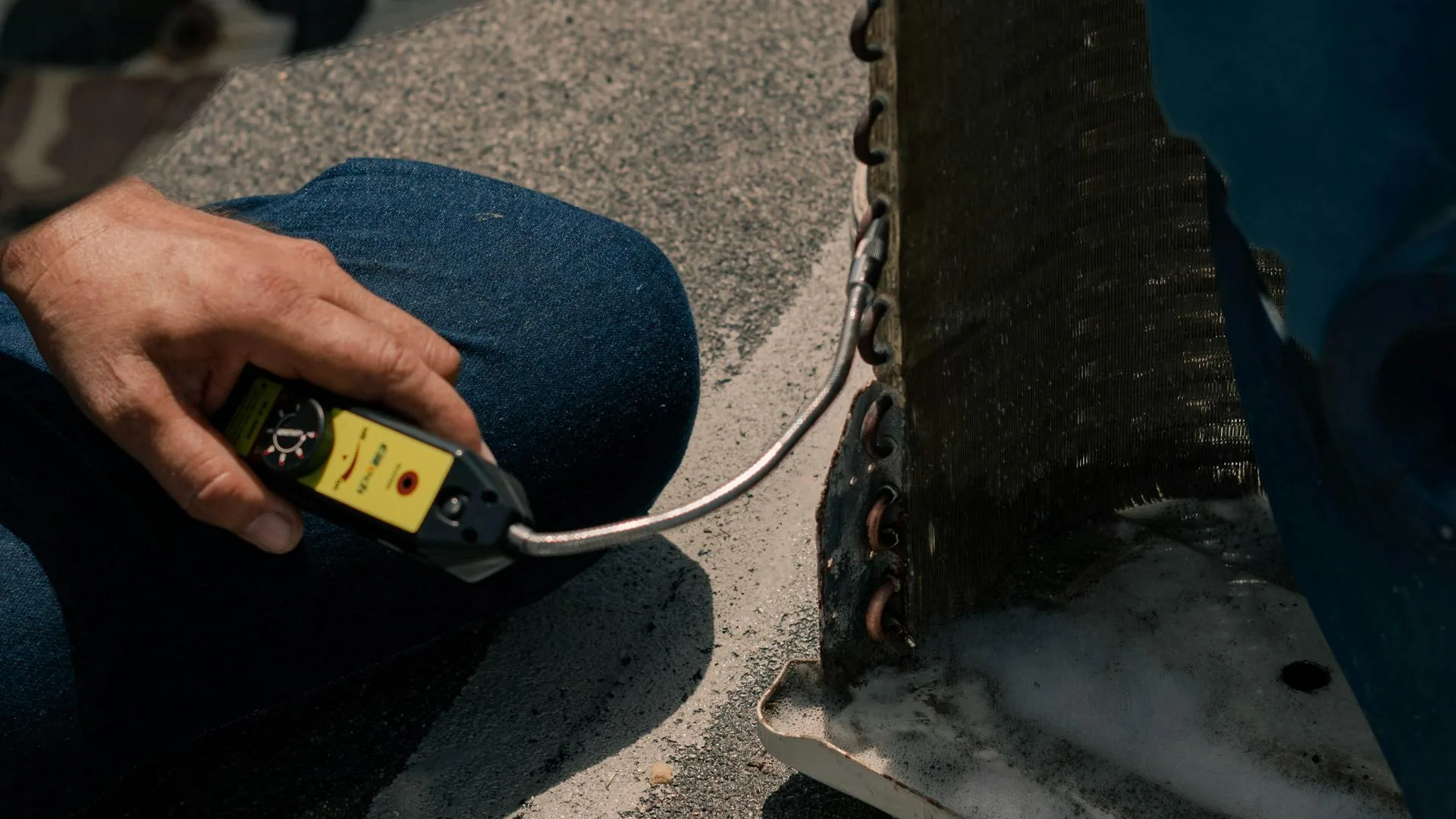 HVAC technician checking AC refrigerant levels to diagnose why AC is not blowing cold air
